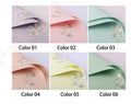 Six sheets of paper in different colors with floral patterns on a light gray background.